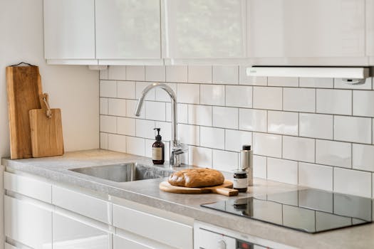 Stylish contemporary kitchen with cutting boards and fresh bread on the counter.