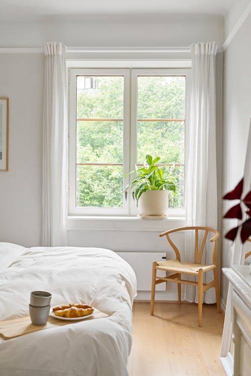 Free Window in a Bedroom and a Wooden Chair Stock Photo