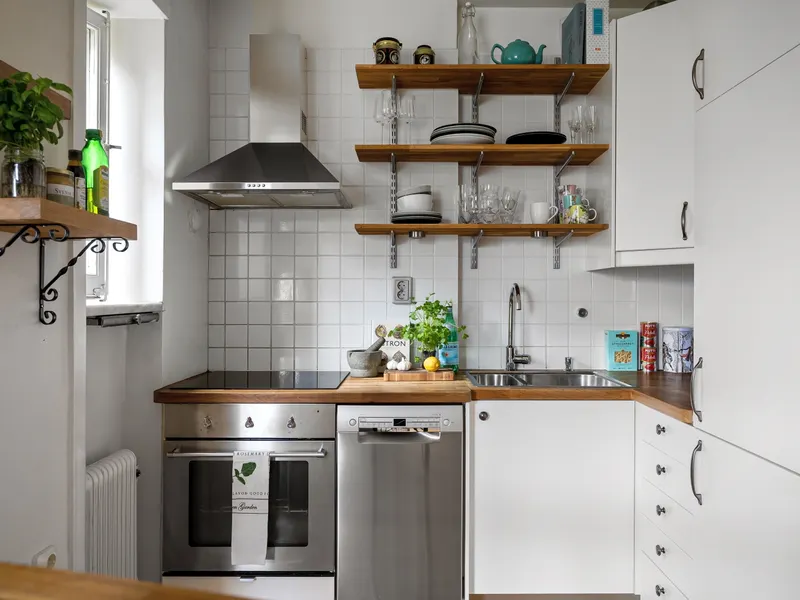 Kitchen with white cabinets and silver appliances including a refrigerator Kitchen with white cabinets and silver appliances including a refrigerator