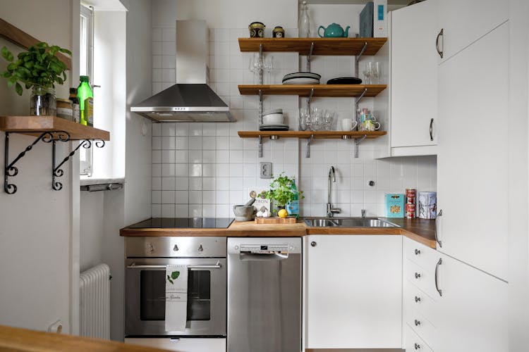 Kitchen With White Cabinets And Silver Appliances