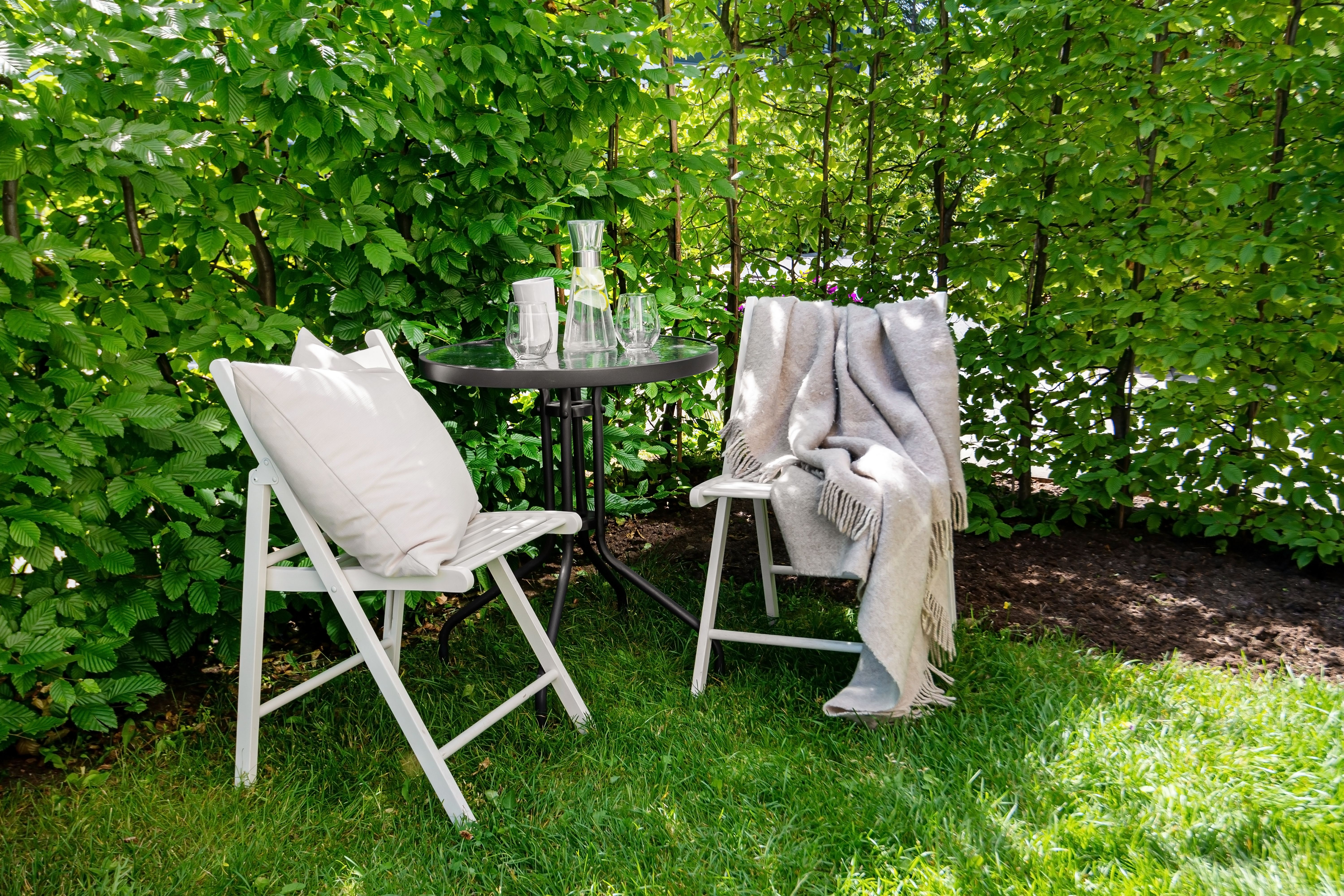 lush garden and patio area in a backyard - concrete pool removal