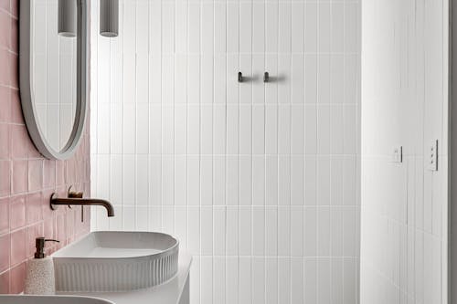 Interior of a Modern Bathroom with White and Pink Tiles 