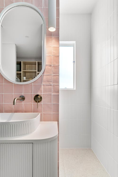 Interior of a Modern Bathroom with White and Pink Tiles 