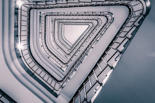 Low Angle Shot of Triangle Stairs in a Tall Building 