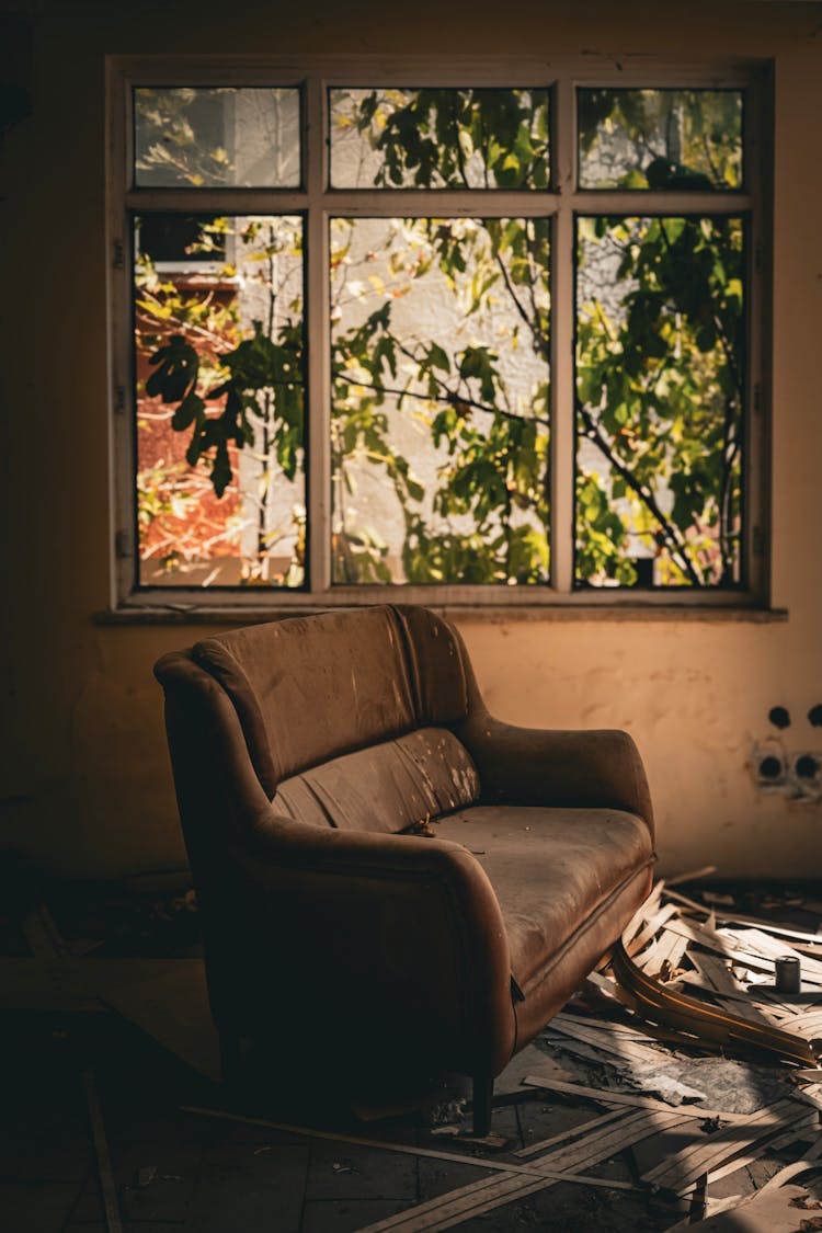 A Damaged Sofa Standing In A Room Of An Abandoned House