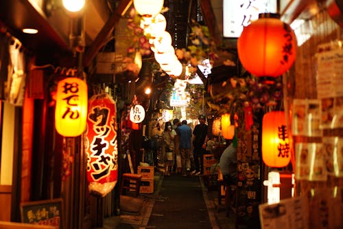 Narrow Alley Illuminated by Glowing Paper Lanterns at Night