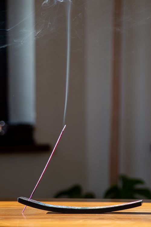 Smoking Purple Incense Stick on a Stand