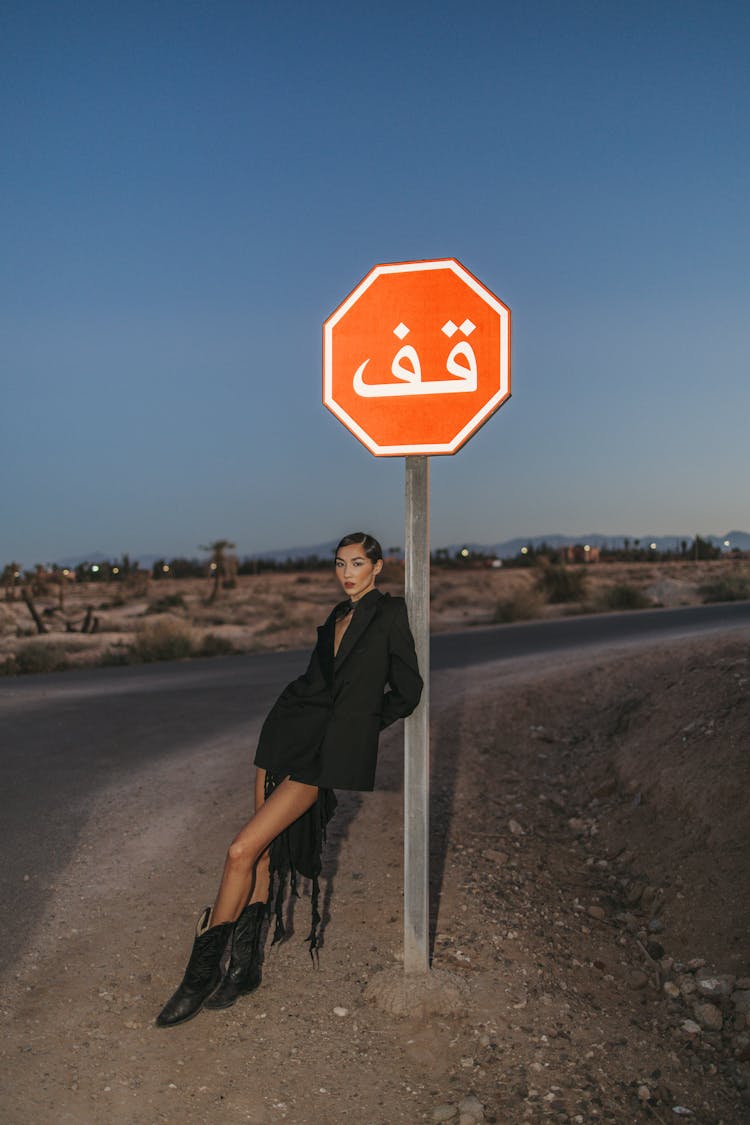 Woman Leaning On Stop Sign