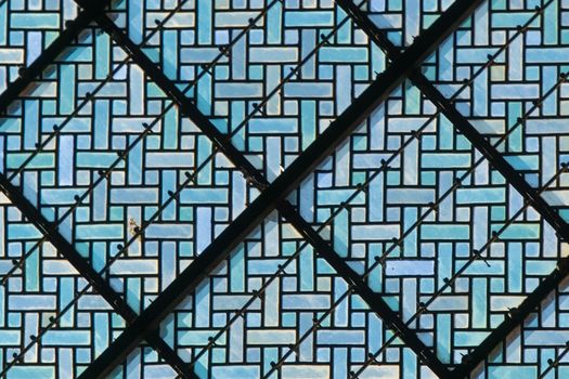 Detailed view of a blue stained glass pattern showcasing an abstract geometric design. — photo by Jan van der Wolf
