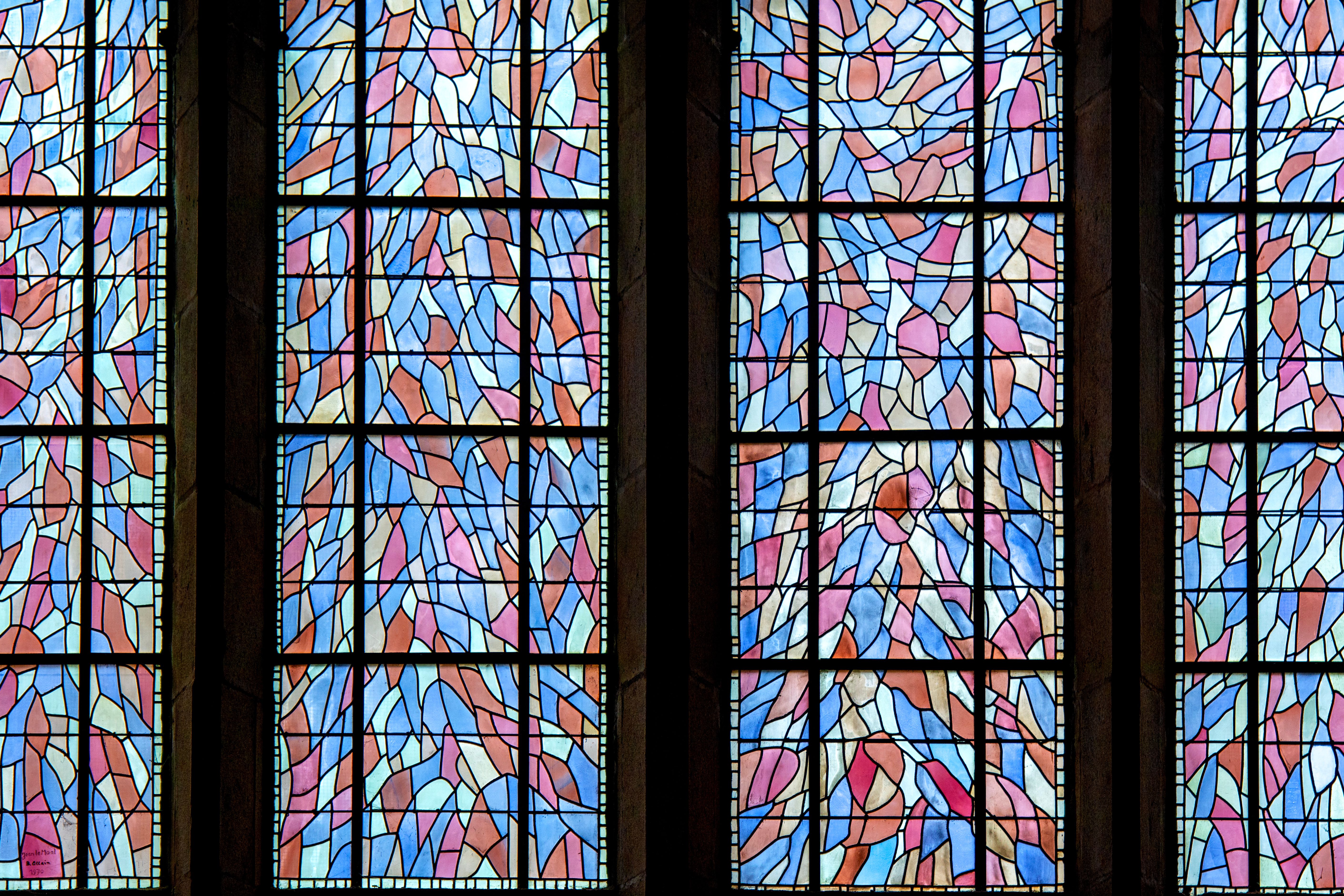 Vibrant stained glass art showcases intricate designs in church windows.