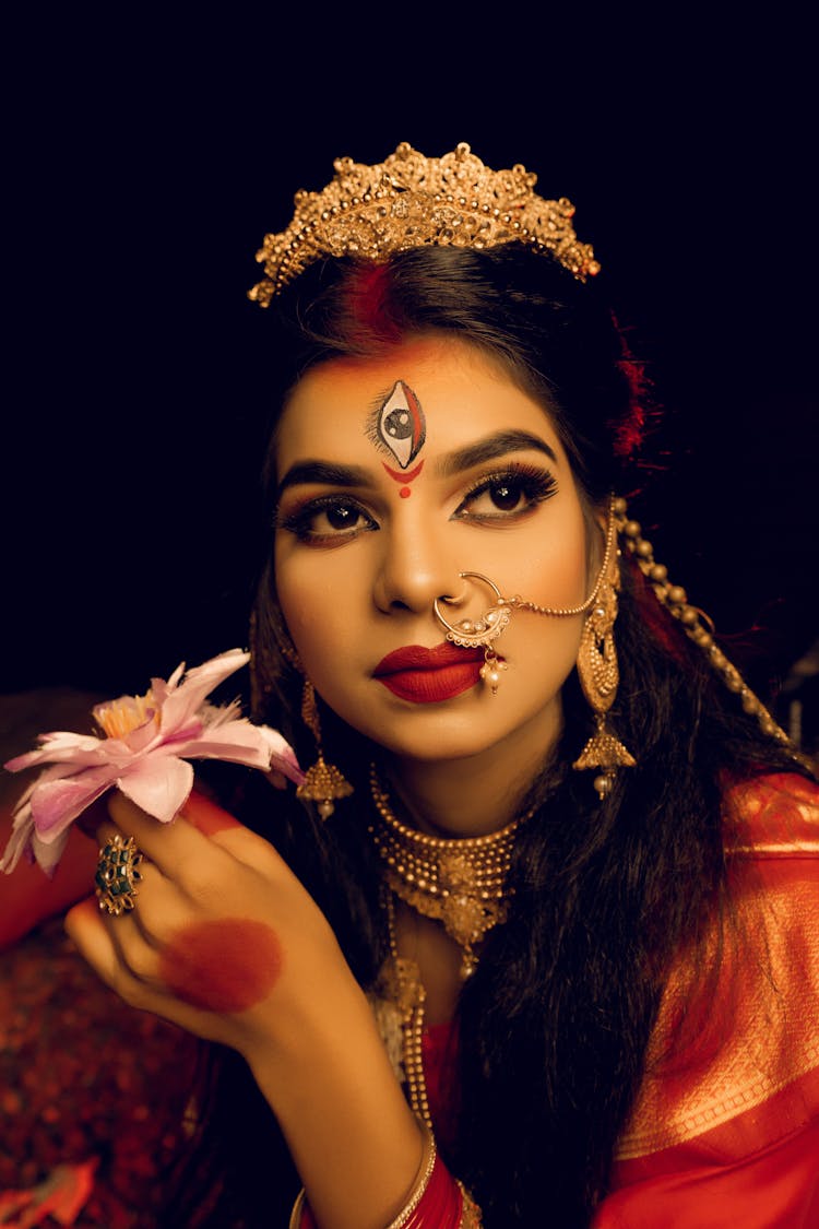 Portrait Of Woman With Flower And Golden Jewelry