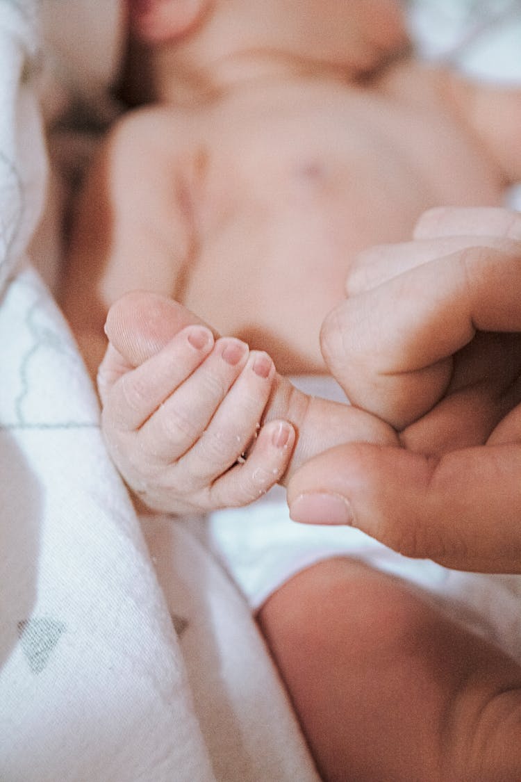 Newborn Holding Parent Finger