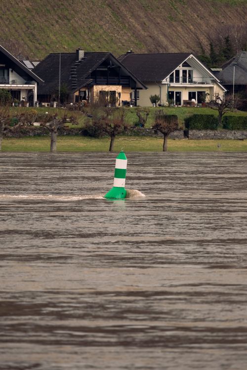 Free Picturesque rural village by a river with a prominent buoy in the water. Stock Photo