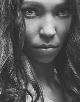 Intense black and white portrait capturing the emotion in a woman's gaze.