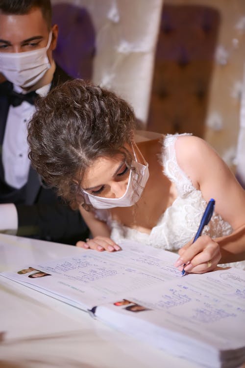 Bride Writing in the Registry Book during a Civil Wedding 