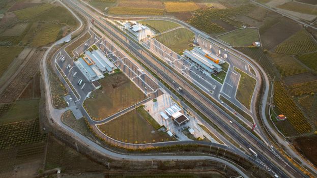 Aerial image showcasing a complex highway interchange in Şehzadeler, Manisa at sunset.