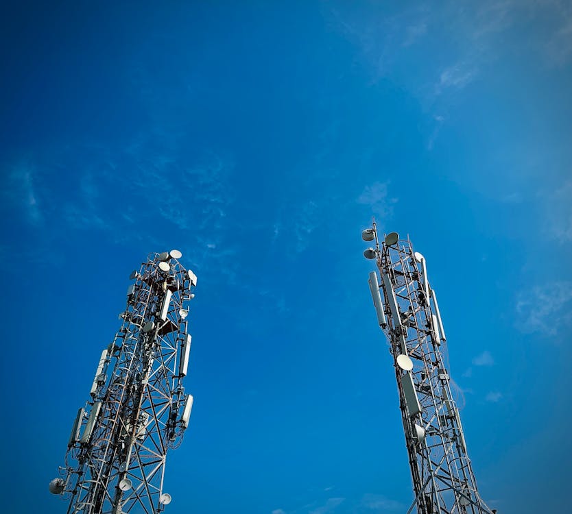 Low Angle Shot of Telecommunications Towers under Blue Sky 