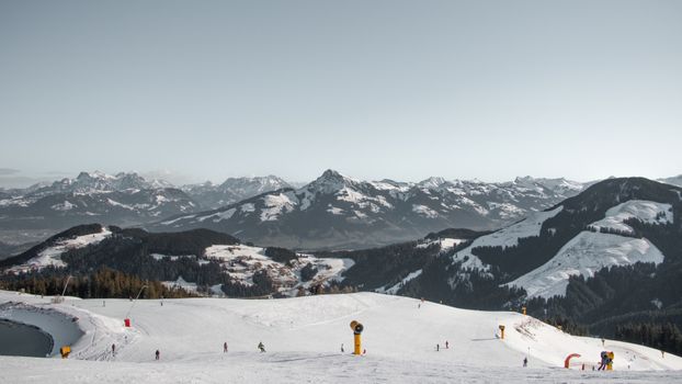 Scenic winter landscape of snow-covered mountains and ski slopes in Brixen im Thale, Tirol, Austria.