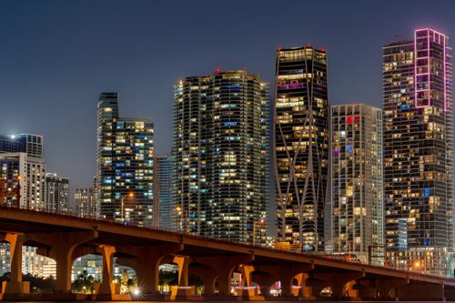Free Captivating view of Miami's illuminated skyline and skyscrapers at night. Stock Photo