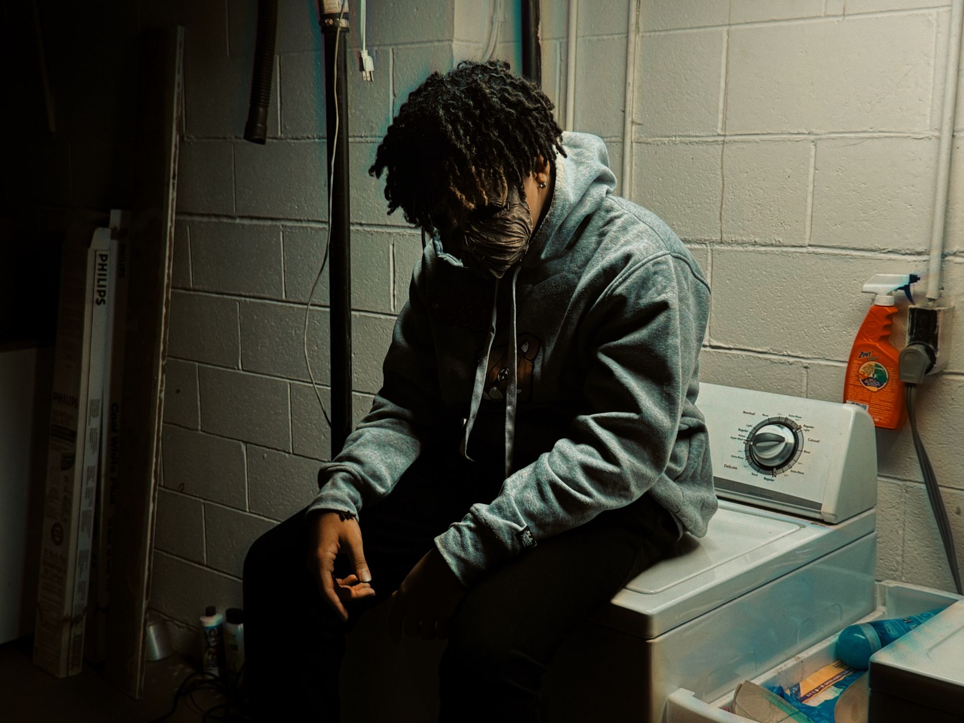 A Man Sitting on a Washing Machine