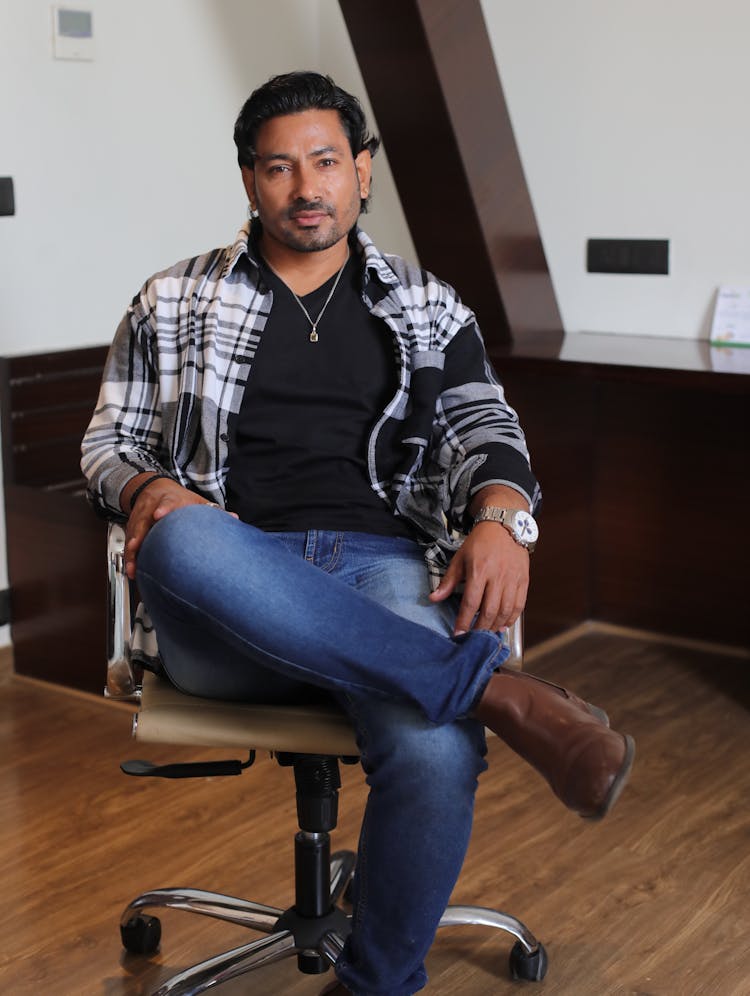 Man In Jeans Sitting On Chair