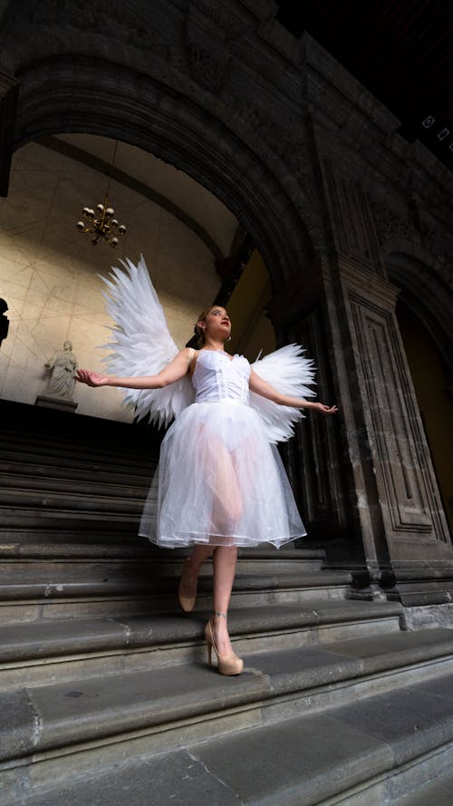 Woman in White Dress with Angel Wings