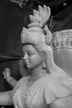 Monochrome close-up of Goddess Durga sculpture in Mumbai workshop, highlighting intricate artistry and cultural significance.