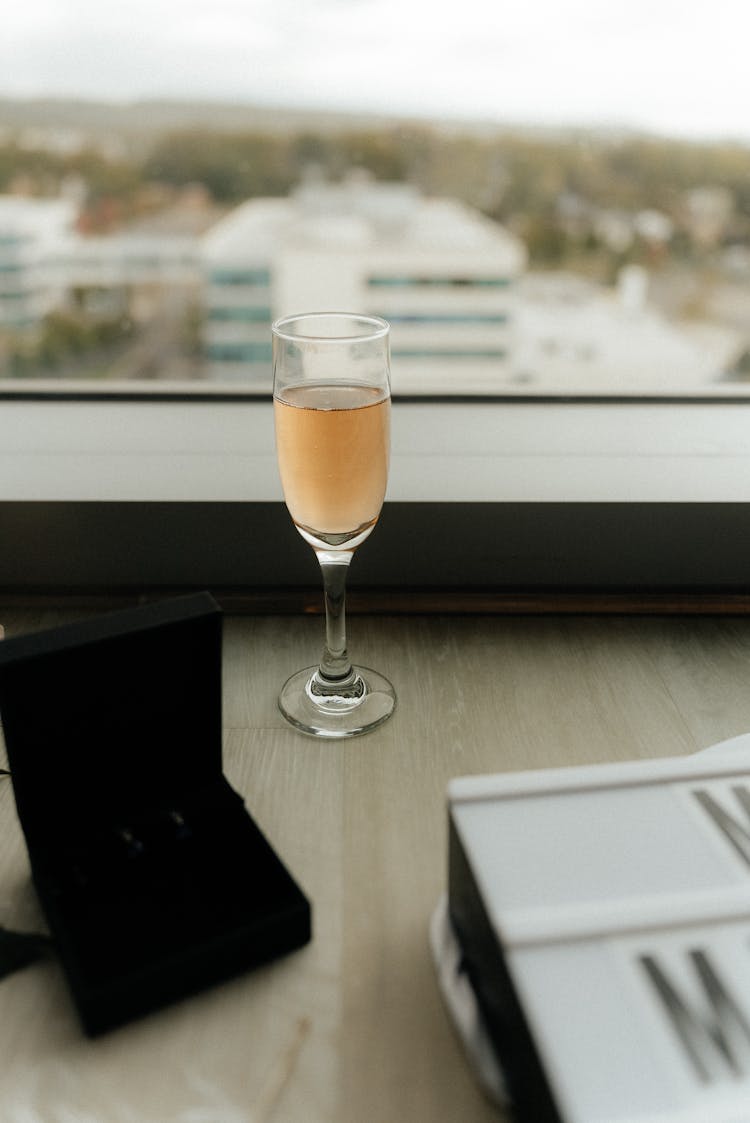 A Glass Of Champagne Standing By The Window 