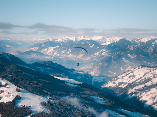 People Parachuting in Mountains in Winter