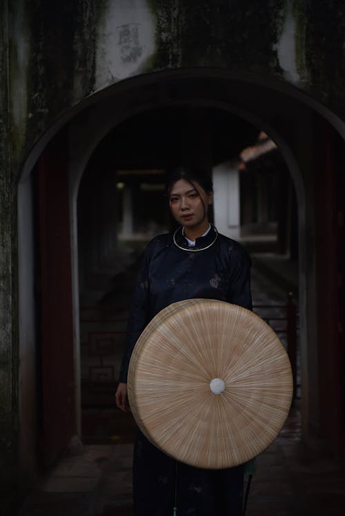 Woman in Traditional Clothing Standing with Basket