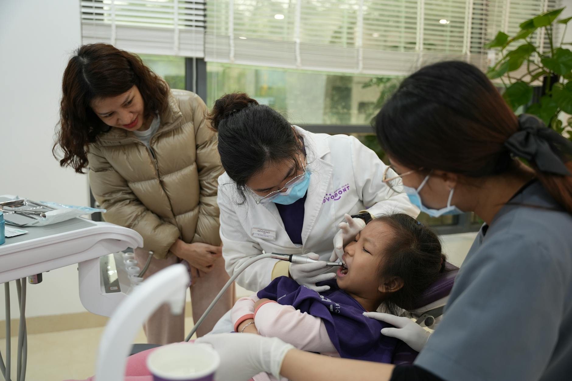 A woman and two children in a dental office