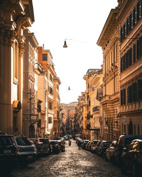 Serene view of a historic European city street lined with buildings at sunrise.