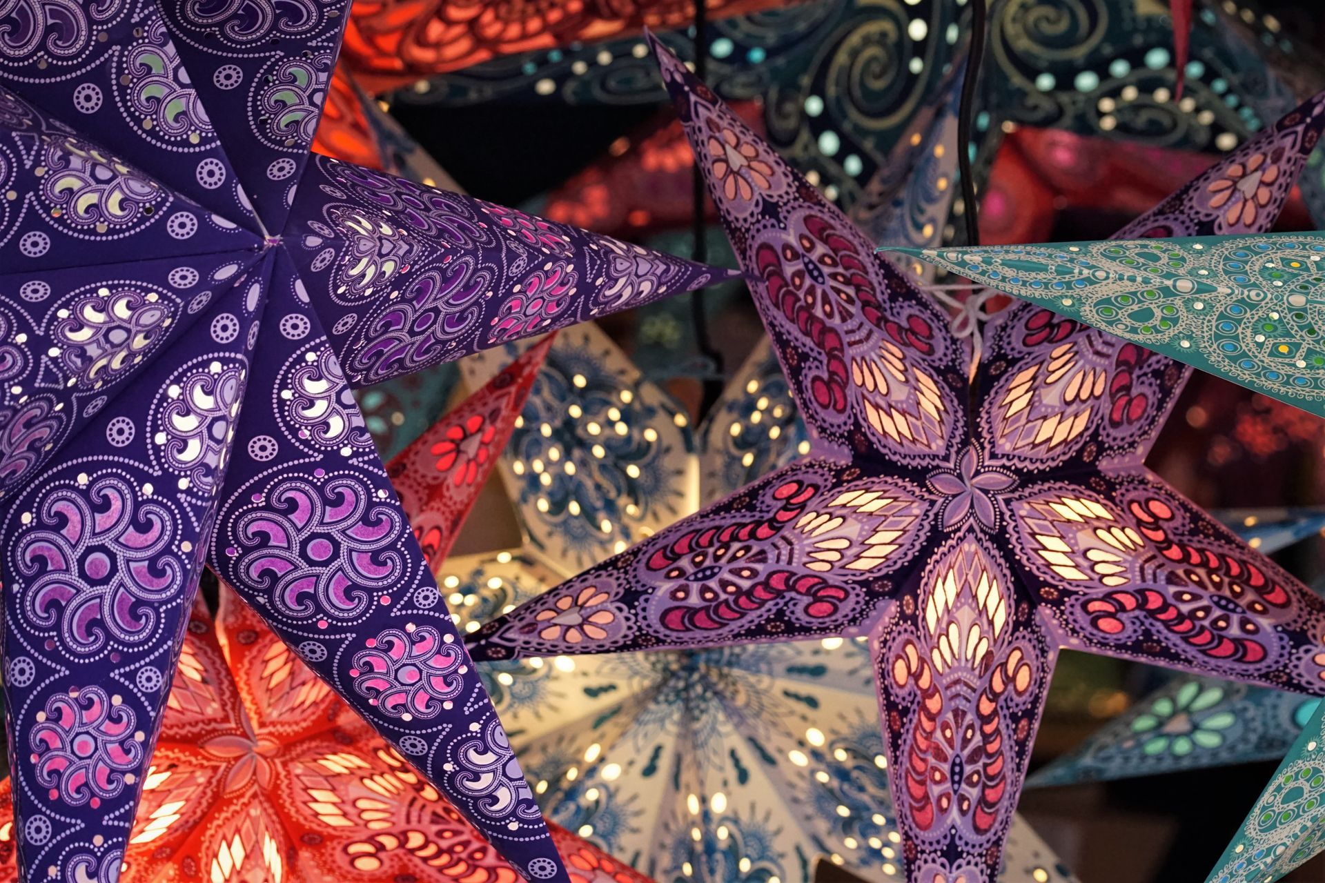 Vibrant and artistic paper star lanterns creating a festive ambiance indoors.