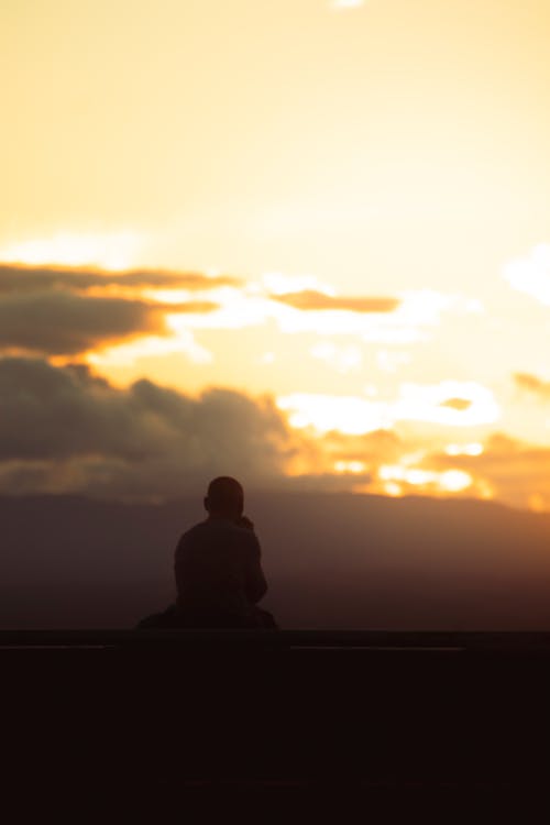 Buddhist Monk Meditating at Sunset