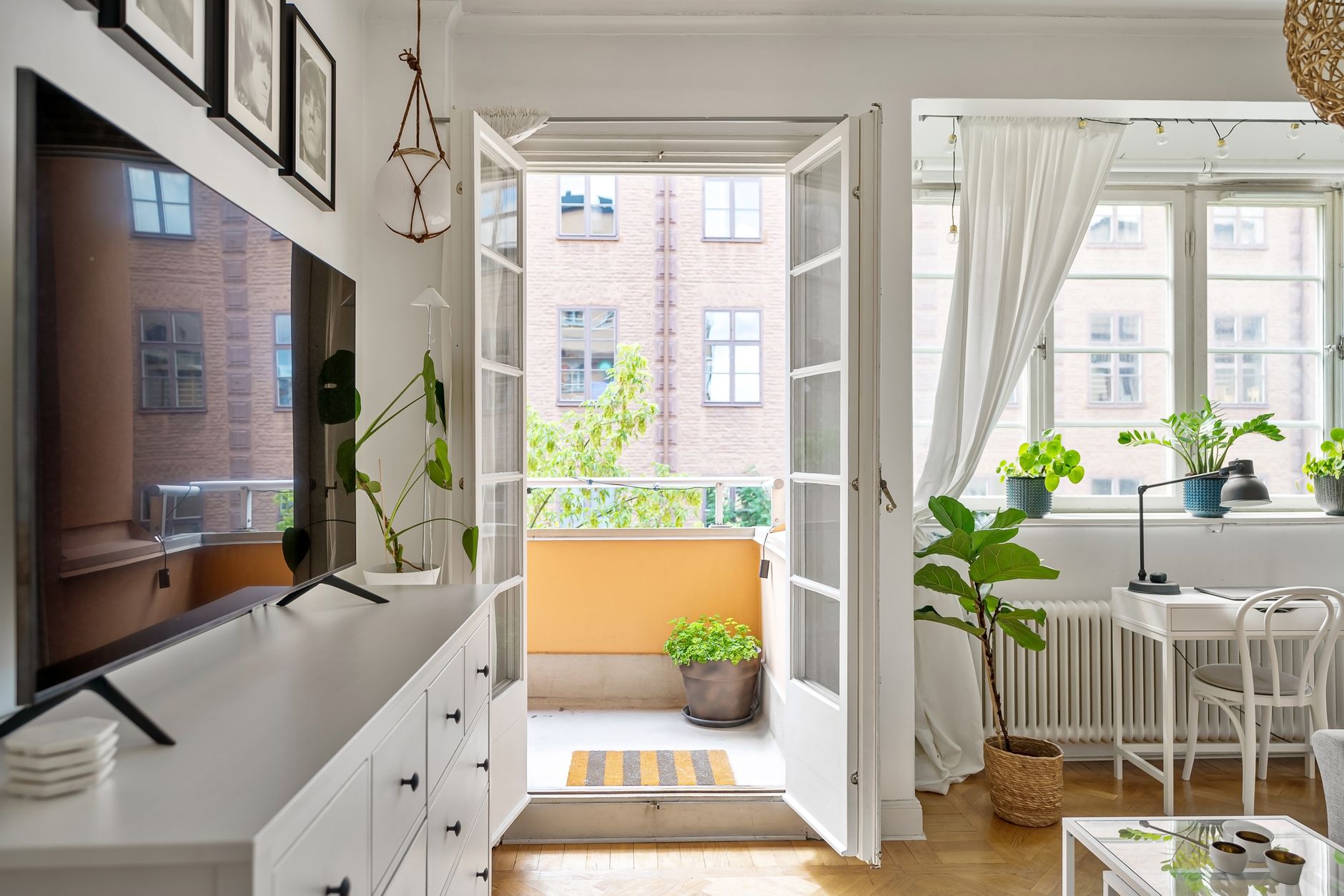 scandinavian balcony layout for cozy homes Cozy Scandinavian-style living room with a sunlit balcony and modern decor.