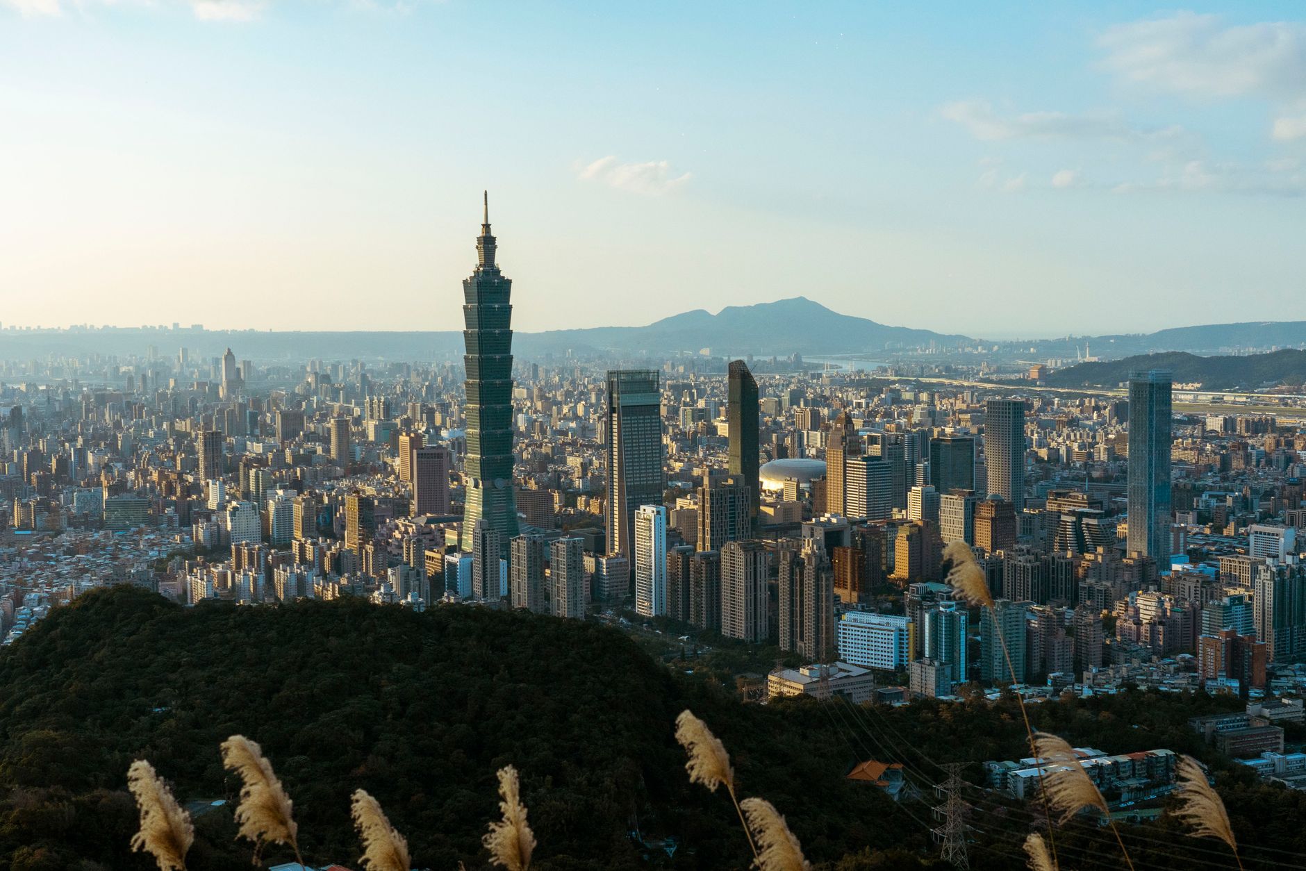 Discover the breathtaking skyline of Taipei featuring the iconic Taipei 101 skyscraper on a clear day.