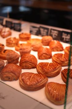 A mouthwatering assortment of pastries in a bakery shop display, perfect for indulgence.