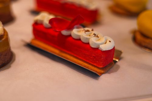 Free Elegant red velvet pastry topped with whipped cream and decoration, perfect for gourmet presentations. Stock Photo