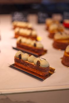 Enticing selection of gourmet pastries on display in a modern bakery setting, perfect for food lovers.