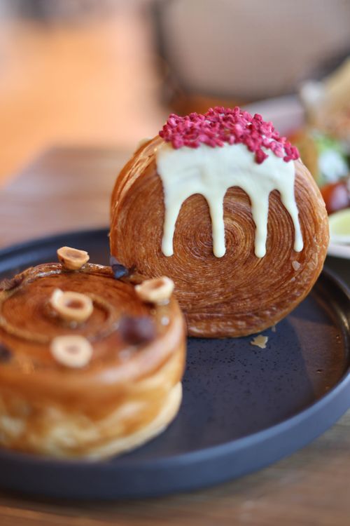 Free Close-up of sweet pastries with icing and nuts on a plate, perfect for dessert lovers. Stock Photo