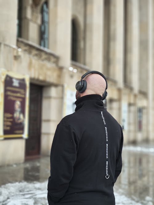 Back View of Bald Man in Headphones