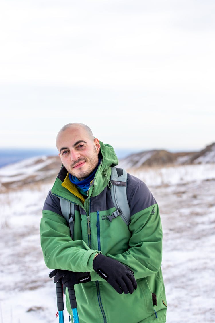 Active Man In Green Jacket In Winter