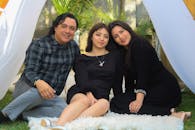 Smiling Man and Women Sitting in Tent