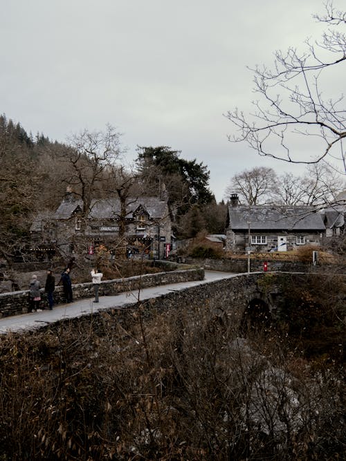 People on Stone Bridge in Village