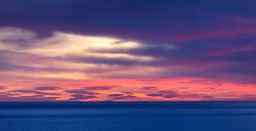 Free Capture of a stunning Mediterranean sunset with vivid colors reflecting on the calm sea. Stock Photo