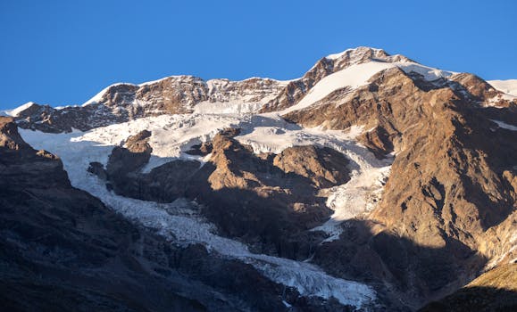 Stunning view of a snow-capped mountain peak in Italy during sunset.