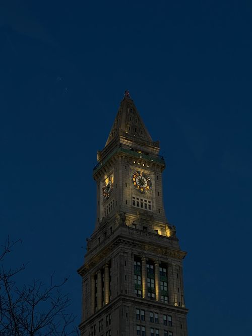 Free A beautifully illuminated clock tower in Boston against the night sky, showcasing elegant architecture. Stock Photo