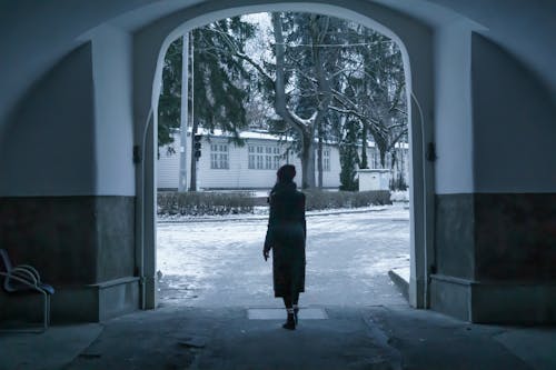 Woman Walking out Walkway in Winter