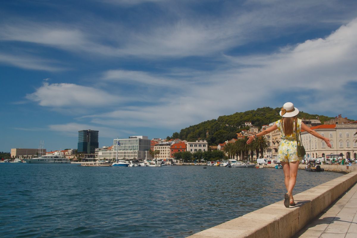 Tourist walking along Split waterfront promenade in Croatia