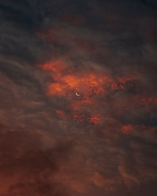 Crescent Moon in Red Cloudy Night Sky